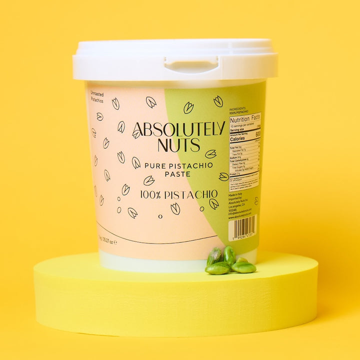 Container of 'Absolutely Nuts' pistachio paste on a yellow background