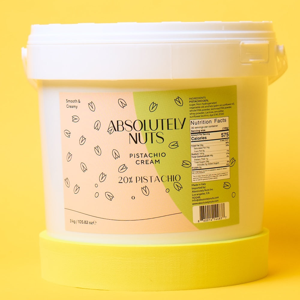 Bucket of Absolutely Nuts Pistachio Cream on a yellow background