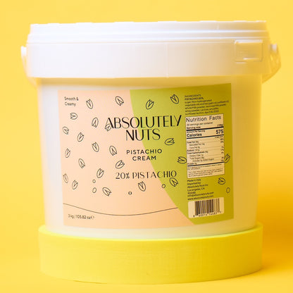 Bucket of Absolutely Nuts Pistachio Cream on a yellow background