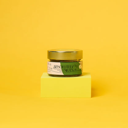 Jar of 'Absolutely Nuts' on a yellow block with a yellow background