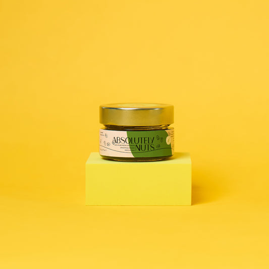 Jar of 'Absolutely Nuts' on a yellow block with a yellow background