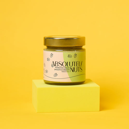 Jar of 'Absolutely Nuts' pistachio cream on a yellow background